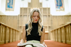 Student reading the Bible in the Chapel. 
